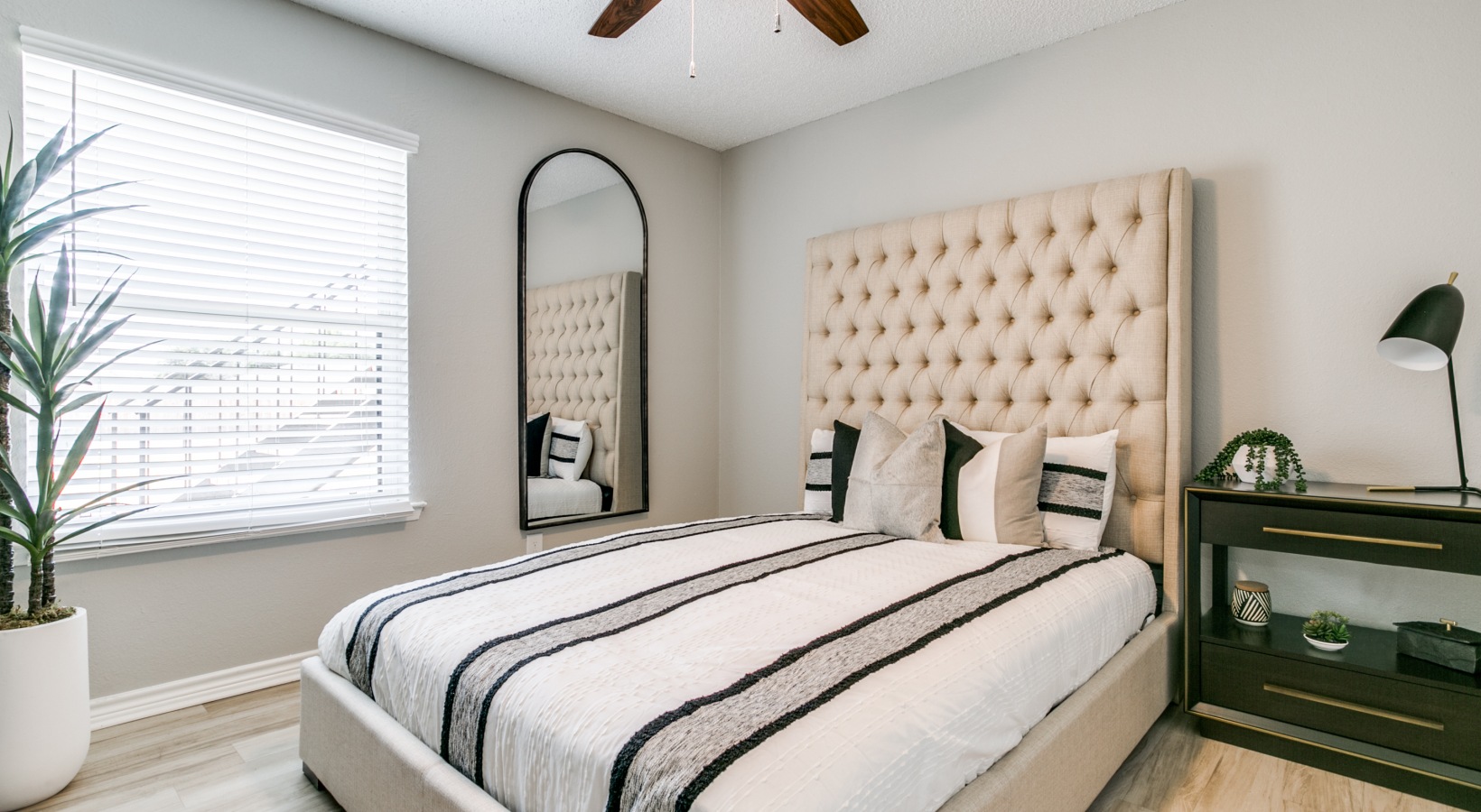 a bedroom with a white bed and a ceiling fan at The  Holden