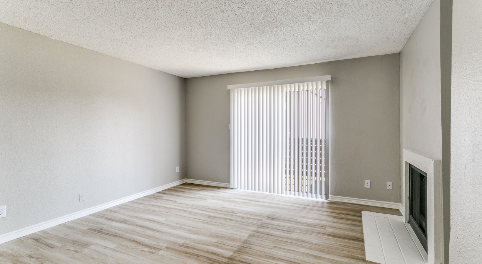 empty room with hardwood floors and sliding glass door at The  Holden